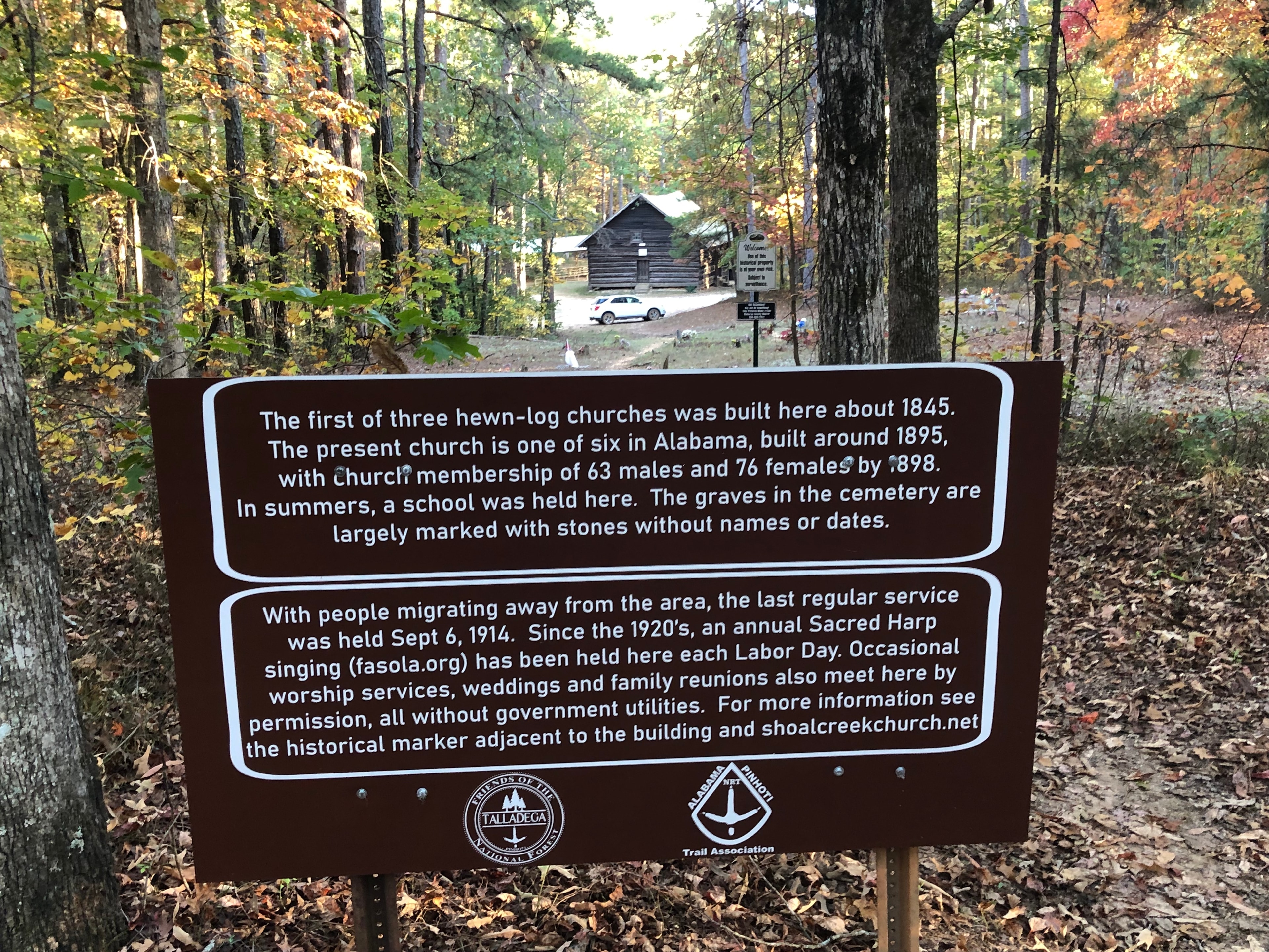 Signage on the adjacent Pinhoti Trail and footpath through the graveyard to the church.